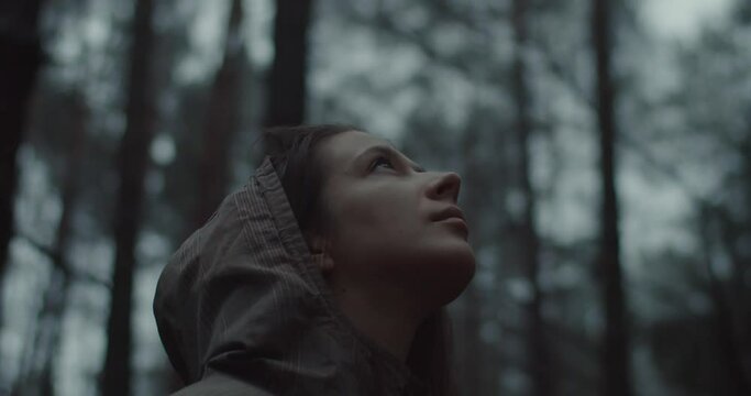 Close-up Portrait Of Young Girl Stands In Forest And Dream About Something. Beautiful Woman Without Make-up Looking Up At Sky And Enjoys Nature. Teen Girl Face Opening And Clothing Eyes Outdoors