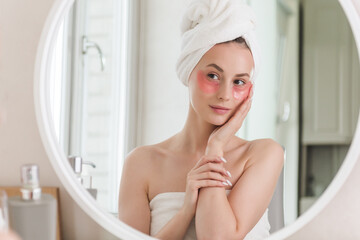 Portrait of Beauty woman with eye patches showing an effect of perfect skin. Beautiful face of young adult woman with clean fresh skin and bare shoulders.