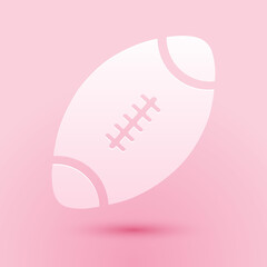 Paper cut American Football ball icon isolated on pink background. Paper art style. Vector.