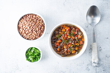 Green Lentil carrots red pepper vegan soup in a bowl