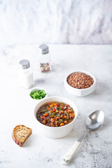 Green Lentil carrots red pepper vegan soup in a bowl