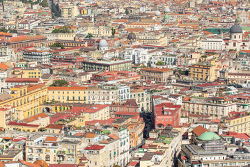 Fototapeta na wymiar Naples, Italy - heavily bombed during World War II, Naples has seen a savage urbanization in the 60s. Here in particular the wild and colorful skyline 