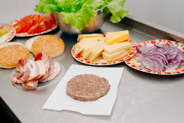 Raw burger cutlet. The process of making a burger in the kitchen in a diner.