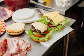 the process of making a burger in the kitchen in a diner, in the foreground is bacon