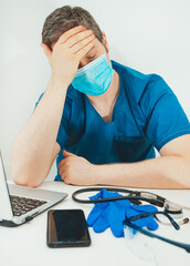 Tired medical doctor in protective mask. Burnout at work.