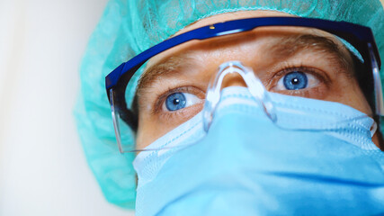 Medical worker wearing mask and glasses.