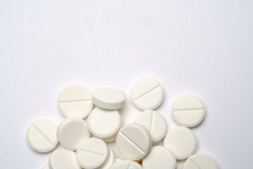 Heap of pills tablets over light grey background