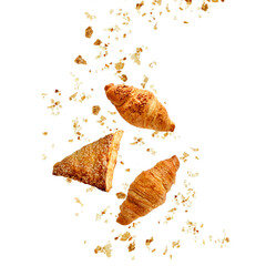 Apple turnover, butter and almond nut croissants flying with crumbs isolated on white