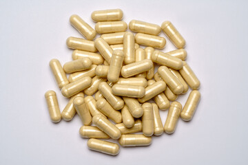 Heap of pills capsules over light grey background