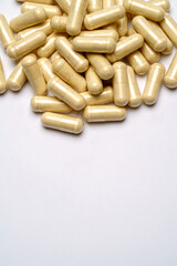 Heap of pills capsules over light grey background