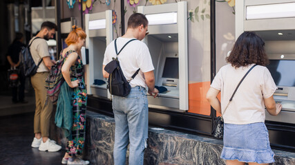 Line to ATM. Group of people waiting to withdraw money to bank card using ATM cash machine. Bank...