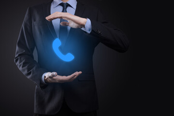 Businessman man in suit on black background hold phone icon.Call Now Business Communication Support Center Customer Service Technology Concept.