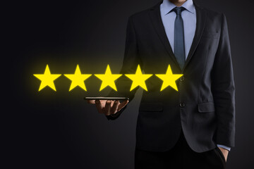 Man hand showing on five star excellent rating.pointing five star symbol to increase rating of company.Review, increase rating or ranking, evaluation and classification concept
