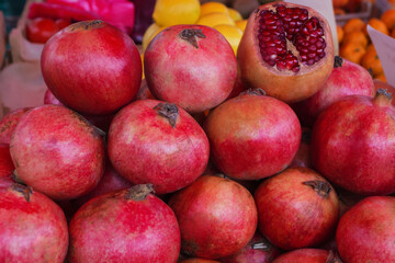 Background of ripe red pomegranates. Pomegranate are sold on the market. Punica granatum fruit close up. Of pomegranate to produce a delicious juice.