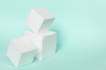 White rectangular cube shapes on blue background. Minimal boxes geometric forms podium. Empty unbranded shopfront. Showcase for cosmetic product. Mockup style design. Cosmetology and beauty concept.