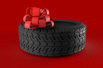 Car tire with red bow.
