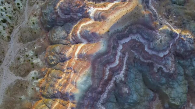 Cinematic aerial flyover of colorful sandstone strata at sunset in Southern  Utah
