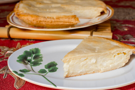 A slice of buko pie, a Filipino-style coconut pie made of fresh, tender coconut meat combined with creamy filling and enclosed in a flaky pie crust.