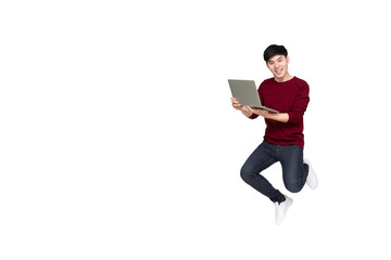 Excited Asian man jumping and holding laptop computer with celebrating success isolated over white background