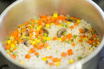 rice with vegetables in a stainless steel pot