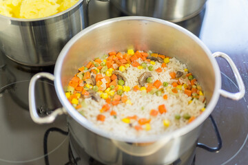 rice with vegetables in a stainless steel pot