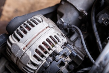 Close-up of the generator on an engine with a bypass belt is a part in the form of a rubber ring...