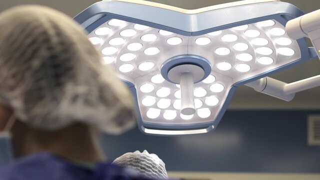 Surgeon doctor operating wearing special lamp lighting using electric cautery heart surgery intervention close-up, open cord surgery minimally invasive surgery