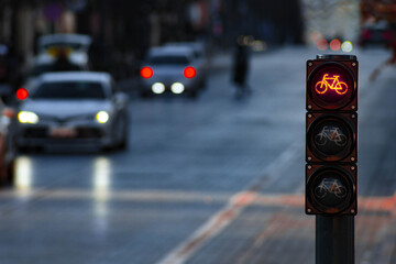 Sustainable transport. Bicycle traffic signal, red light, stop sign, road bike, free bike zone or area, bike sharing, with traffic on background 