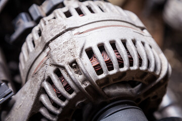 Close-up of the generator on an engine with a bypass belt is a part in the form of a rubber ring...