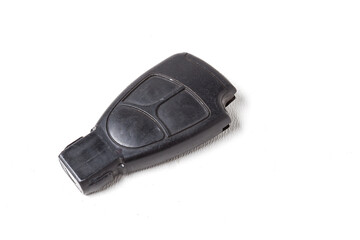 Car key with a chip and with buttons for opening and closing the central locking control, isolated on a white background in a photo studio.