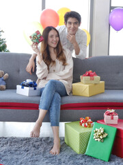 Asian couple lovers giving and getting gift in Christmas festival holiday