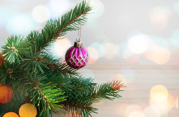 Fototapeta na wymiar small ball on a Christmas tree branch with bokeh