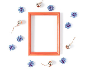 Christmas composition. Empty wooden photo frame, golden balls and blue bows are on a white background. New Year card. Flat lay, top view, copy space.