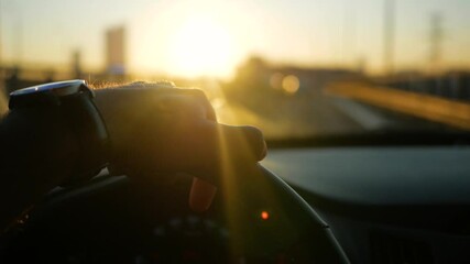Young adult successfull male driving on road trip at sunset. Driving car towards bright scenery sun pleasure shining over the road. Driver traveling by automobile. Enjoying sunset sky. Freedom inspire - Powered by Adobe