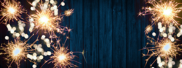 New Year - Silvester Party background banner panorama long- sparklers, firework and bokeh lights on...