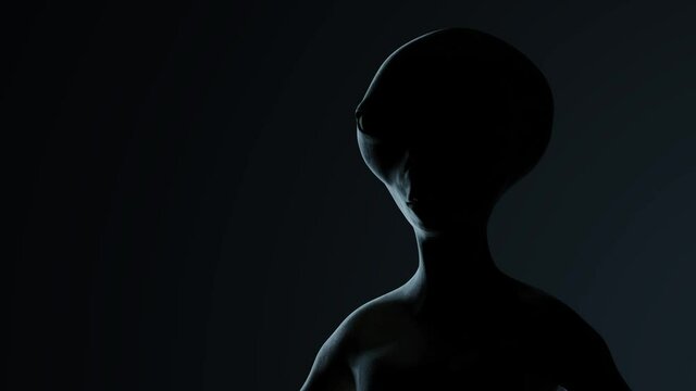 Spooky alien's face on black background. UFO and extraterrestrial life concept.