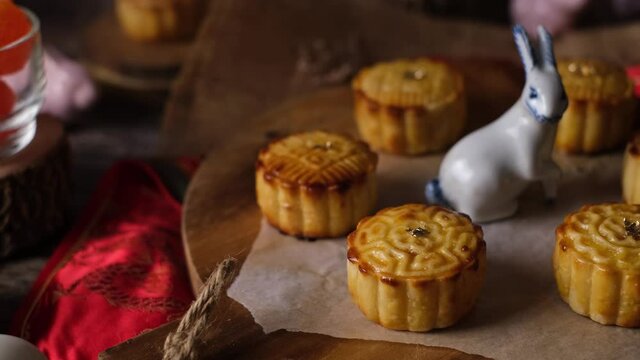 Mooncake a Chinese traditional pastry for Mid-Autumn festival. set on rustic wooden table.