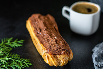 eclairs chocolate-covered in chocolate berry cut cream profiteroles ready to eat on the table healthy meal snack ingredient top view copy space for text food background rustic