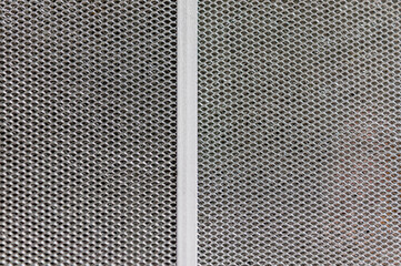 London, United Kingdom, December 05, 2020: Aluminium mesh pattern on black gradient background...