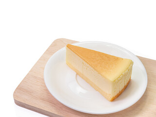 The close up of sliced yummy cheesecake bakery sweet dessert on wood cutting board isolated on white background.