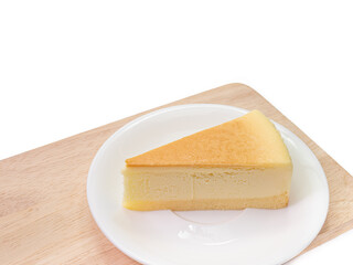 The close up of sliced yummy cheesecake bakery sweet dessert on wood cutting board isolated on white background.
