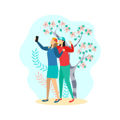 Two girlfriends take a selfie on the phone. Friendship, photo, park, trees, plants