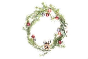 Christmas frame on a white background of fir branches and Christmas decorations.