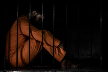 Asian man desperate at the iron prison,prisoner concept,thailand people,Hope to be free,Serious...