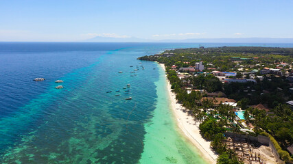 Beautiful Alona beach and blue sea in Panglao island, Bohol, Philippines. Holiday and vacation concept. Tropical beach.