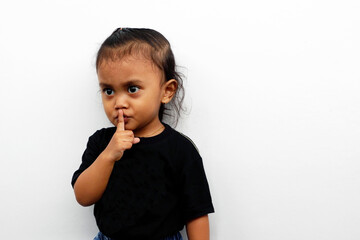Little girl expression wearing a black t-shirt isolated on white background.
