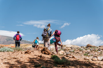 Group of Tourists in Summer Mountain Landscape. Travel location of popular attraction. View of beautiful nature.