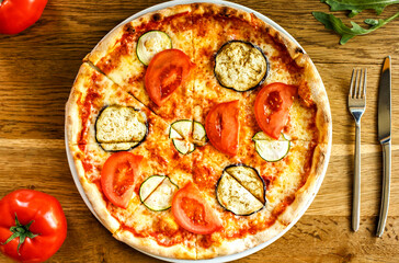 Cripsy vege pizza served on a wooden table in trattoria italiana