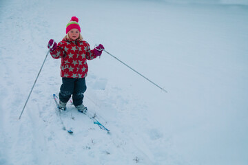 Fototapeta na wymiar little girl ski in winter nature, kids active lifestyle, winter sport