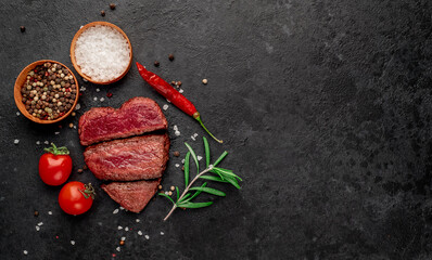 Three pieces of meat. three types of roast meat, rare, medium, well done in the shape of a heart on a stone background with space for text